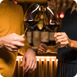 Two people toasting red wine at a Wine Event